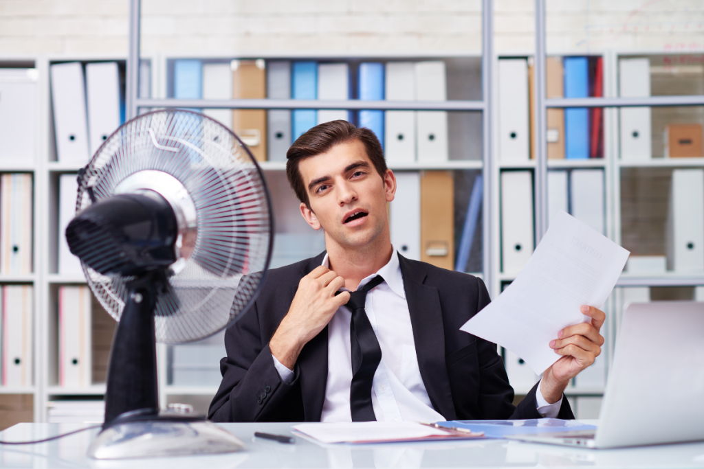 A Person Overheating In An Office - Springbank Mechanical Toronto HVAC Company