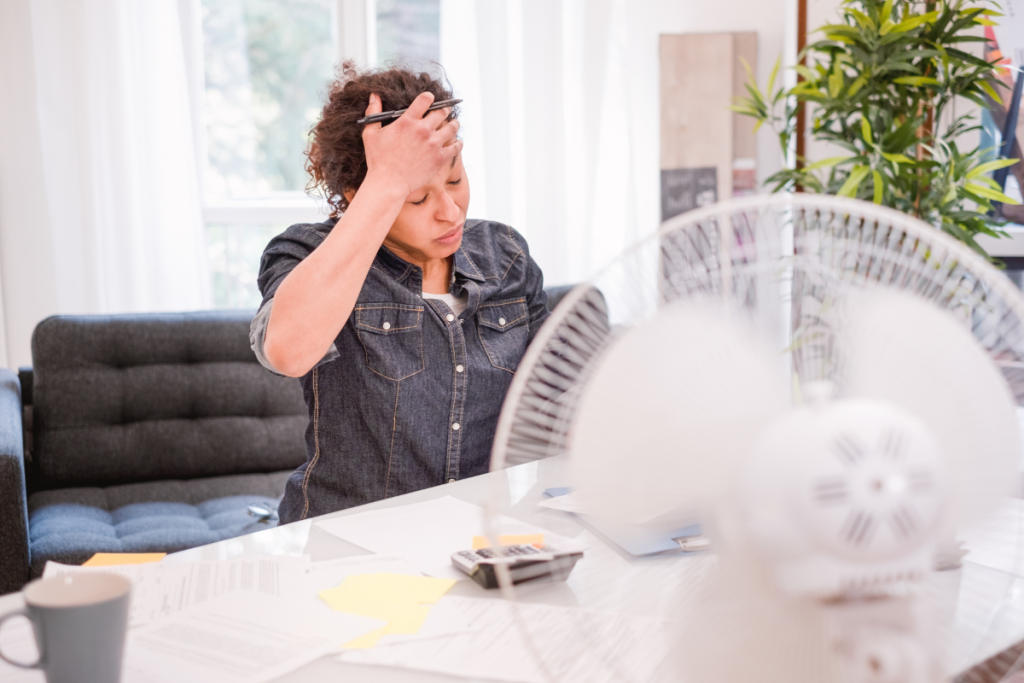 An Office Worker Over Heating In The Summer - Springbank Mechanical Toronto HVAC Company