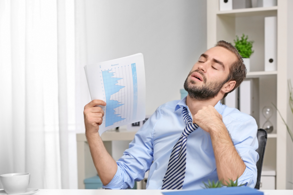 An office Worker fanning a paper to cool down - HVAC Refrigeration System Springbank Mechanical Toronto