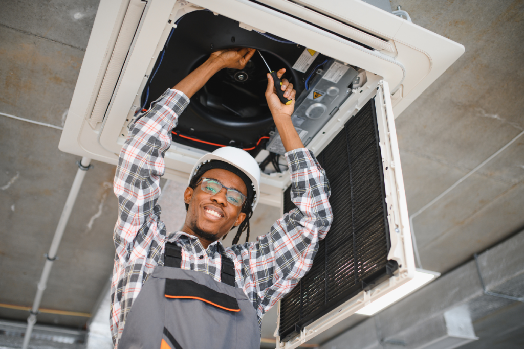 A Person Working On A Commercial HVAC System - Springbank Mechanical